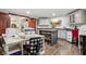 Large craft room featuring wood floors, an island, white cabinets, sewing machines, and doorway to exercise room at 8362 N County Road 650 E, Brownsburg, IN 46112
