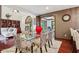 Elegant dining room with a glass table, unique chairs, and an adjacent sitting area at 8362 N County Road 650 E, Brownsburg, IN 46112