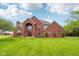 Stunning two-story brick home with large windows and lush green lawn under a partly cloudy blue sky at 8362 N County Road 650 E, Brownsburg, IN 46112
