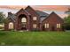 Traditional brick home with a grand entrance, manicured lawn, and professionally landscaped front yard at 8362 N County Road 650 E, Brownsburg, IN 46112