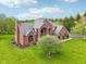 Stunning brick home with well-manicured lawn and mature trees offering a picturesque setting at 8362 N County Road 650 E, Brownsburg, IN 46112