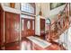 Grand foyer showcasing a staircase, hardwood floors, and a large arched window with an abundance of natural light at 8362 N County Road 650 E, Brownsburg, IN 46112