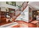 Inviting foyer with hardwood floors, a wooden staircase, and a glimpse into the bright and airy living spaces at 8362 N County Road 650 E, Brownsburg, IN 46112