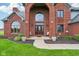 Elegant front entrance with a decorative door, sidelights, and manicured landscaping, creating curb appeal at 8362 N County Road 650 E, Brownsburg, IN 46112
