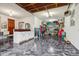 Garage with epoxy floor, white cabinets, sink, stainless refrigerator, and additional storage at 8362 N County Road 650 E, Brownsburg, IN 46112