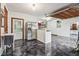Garage with epoxy floor, fridge, sink, white cabinetry, and door to the side yard at 8362 N County Road 650 E, Brownsburg, IN 46112