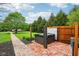 Private hot tub area with a wooden fence, a brick patio, and lush greenery, creating a relaxing outdoor oasis at 8362 N County Road 650 E, Brownsburg, IN 46112