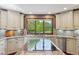 Bright kitchen features granite countertops, stainless appliances, and a large window overlooking a lush yard at 8362 N County Road 650 E, Brownsburg, IN 46112