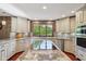 Bright kitchen features granite countertops, stainless appliances, and a large window overlooking a lush yard at 8362 N County Road 650 E, Brownsburg, IN 46112