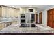 Modern kitchen with granite countertops, stainless steel appliances, and island with cooktop at 8362 N County Road 650 E, Brownsburg, IN 46112