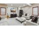 Comfortable living room featuring neutral walls and carpet, stylish couches and chairs, fireplace, and built-in shelves at 8362 N County Road 650 E, Brownsburg, IN 46112