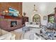 Bright living room featuring a brick fireplace, large windows, and plush seating arrangements at 8362 N County Road 650 E, Brownsburg, IN 46112