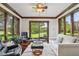 Inviting living room with white sofa, two black leather recliners, a plush rug, and a view of the backyard at 8362 N County Road 650 E, Brownsburg, IN 46112