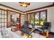 Cozy living room featuring dark wood trim, two black reclining chairs and a view to the property's exterior at 8362 N County Road 650 E, Brownsburg, IN 46112