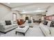 Large living room featuring neutral walls and carpet, stylish couches and chairs, wet bar, and pool table in background at 8362 N County Road 650 E, Brownsburg, IN 46112