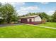 View of outbuilding with large garage door, asphalt driveway and walkway surrounded by green grass at 8362 N County Road 650 E, Brownsburg, IN 46112