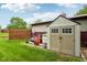 Backyard with a storage shed and an outbuilding against a wooden fence with a large lawn at 8362 N County Road 650 E, Brownsburg, IN 46112
