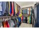 Organized walk-in closet with hanging rods and shelves filled with clothes and accessories at 8362 N County Road 650 E, Brownsburg, IN 46112