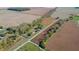An aerial shot of a property surrounded by fields and trees, emphasizing its rural setting at 9056 E 650 N, Wilkinson, IN 46186