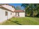 A manicured lawn wraps the back of the home, highlighting its neutral siding and inviting back entrance at 9056 E 650 N, Wilkinson, IN 46186