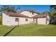 Expansive backyard featuring a well-maintained lawn and the home's charming exterior with brown shutters at 9056 E 650 N, Wilkinson, IN 46186