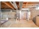 Unfinished basement has cement floors, a utility area and exposed pipes at 9056 E 650 N, Wilkinson, IN 46186