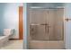 Bathroom features a toilet and bath tub with a clear glass sliding door at 9056 E 650 N, Wilkinson, IN 46186