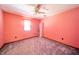 Cozy bedroom featuring a ceiling fan, soft gray carpet, and a bright window at 9056 E 650 N, Wilkinson, IN 46186