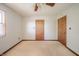 Empty bedroom features light beige carpet, plain white walls, and light-stained wood doors and trim at 9056 E 650 N, Wilkinson, IN 46186