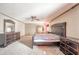 Spacious bedroom showcasing a large, upholstered headboard and matching dresser sets against a light-carpeted floor at 9056 E 650 N, Wilkinson, IN 46186