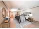 Bedroom features an iron bed frame, a ceiling fan, and a wood dresser with an oval mirror at 9056 E 650 N, Wilkinson, IN 46186