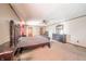 Main bedroom features a large ornate bed, ceiling fan, and a dresser, offering comfort and style at 9056 E 650 N, Wilkinson, IN 46186