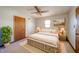 Neutral bedroom featuring a white bed frame with storage drawers, light wood trim, and a ceiling fan at 9056 E 650 N, Wilkinson, IN 46186