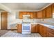 Cozy kitchen with wood cabinets, white countertops, and a view to the kitchen entrance at 9056 E 650 N, Wilkinson, IN 46186