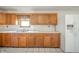 Classic kitchen boasts ample cabinetry, a double basin sink, and modern refrigerator, offering functionality and style at 9056 E 650 N, Wilkinson, IN 46186
