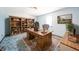 Bright office boasts a beautiful wood desk, built-in bookcase, and tranquil decor, ideal for productivity at 9056 E 650 N, Wilkinson, IN 46186