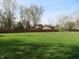 View of a large backyard with a wooden fence at 9113 Church Rd, Brownsburg, IN 46112
