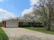 Charming brick ranch home featuring an attached garage and a well-manicured front lawn at 9113 Church Rd, Brownsburg, IN 46112