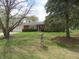 Charming brick ranch home with manicured lawn and mature trees, showcasing a 'For Sale' sign at 9113 Church Rd, Brownsburg, IN 46112