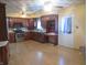 Traditional kitchen featuring wood cabinets, laminate flooring, and modern stainless-steel appliances at 9113 Church Rd, Brownsburg, IN 46112