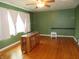 Living room featuring hardwood floors, green walls, natural light, and a unique console table at 9113 Church Rd, Brownsburg, IN 46112
