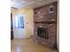 Living room with a brick fireplace and a white door, creating a warm, inviting atmosphere at 9113 Church Rd, Brownsburg, IN 46112