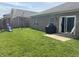 Spacious backyard featuring a playset, well-maintained lawn, and a sliding glass door at 914 Baden Manor Dr, Indianapolis, IN 46217