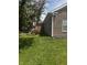 Exterior of brick home with lush green lawn, mature landscaping and red roses at 914 Baden Manor Dr, Indianapolis, IN 46217