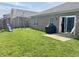 Spacious backyard featuring a playset, well-maintained lawn, and a sliding glass door at 914 Baden Manor Dr, Indianapolis, IN 46217