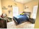 Comfortable bedroom with a large window, a ceiling fan, and a double bed at 914 Baden Manor Dr, Indianapolis, IN 46217