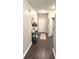 Inviting entryway featuring wood-look floors, a decorative table, and a white front door at 914 Baden Manor Dr, Indianapolis, IN 46217