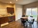 Eat-in kitchen with wood floors and matching cabinets featuring a sliding glass door to the backyard at 914 Baden Manor Dr, Indianapolis, IN 46217