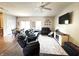 Cozy living room with dark furniture, a ceiling fan, and sliding glass doors at 914 Baden Manor Dr, Indianapolis, IN 46217
