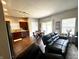 Open concept living room and kitchen featuring wood floors and lots of natural light at 914 Baden Manor Dr, Indianapolis, IN 46217